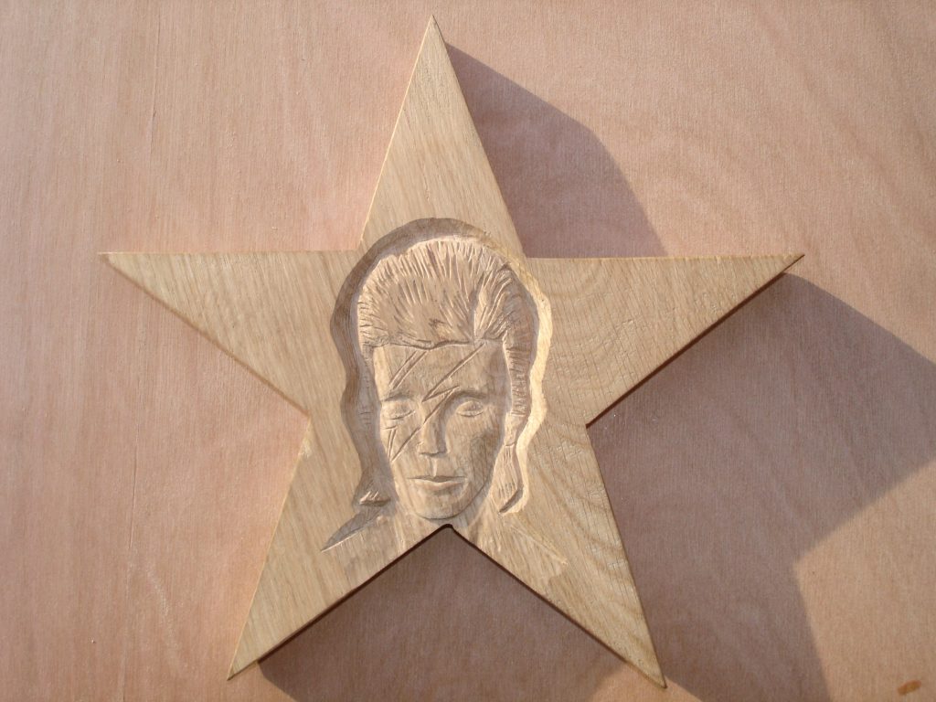 carving of David Bowie as Aladdin Sane in a star