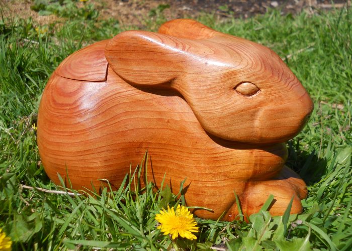 carved wooden rabbit with box in back