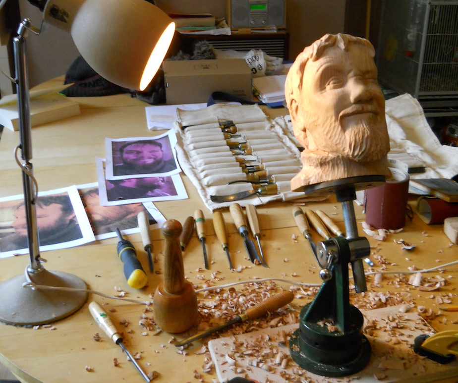 a woodcarving  of a mans head in progress