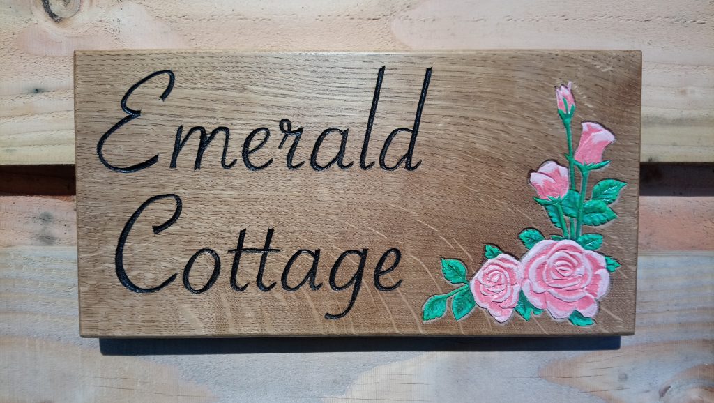An oak sign for 'Emerald cottage'