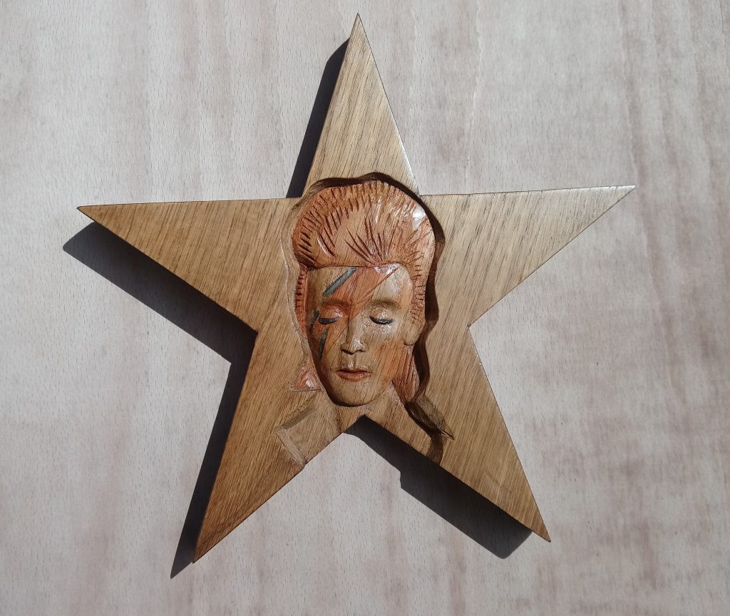 Woodcarving of David Bowie as Aladdin Sane